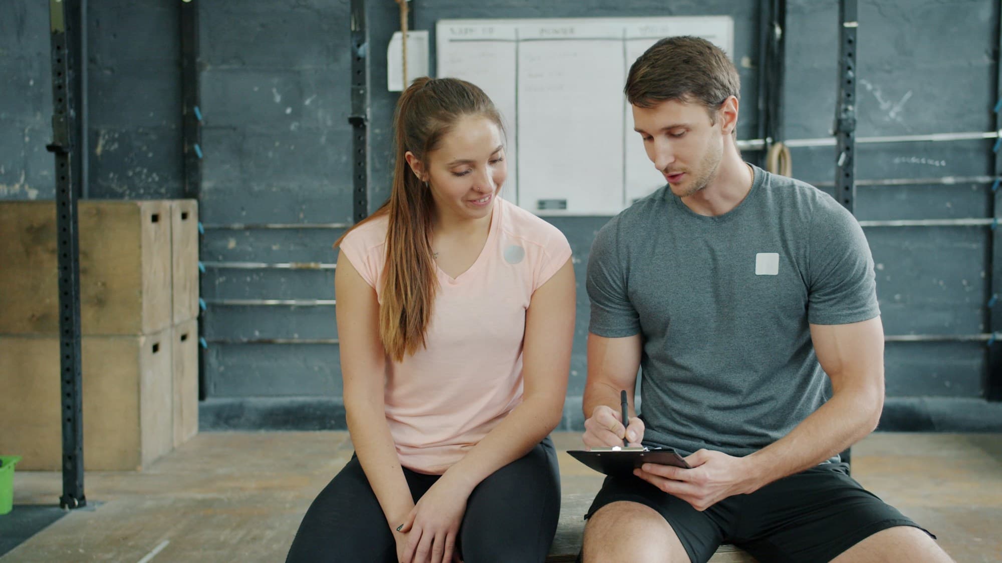 A coach and athlete reviewing a performance plan together